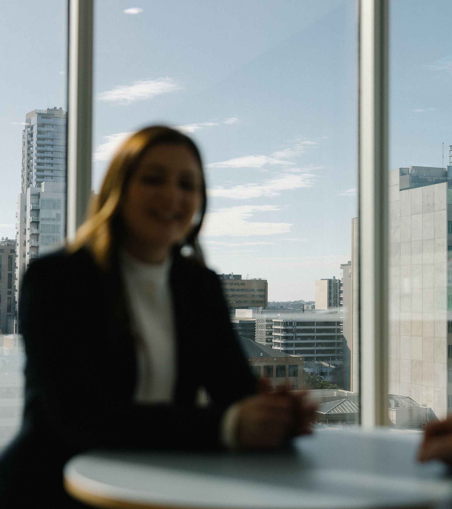 Man and woman sitting at a table with city scape in background
