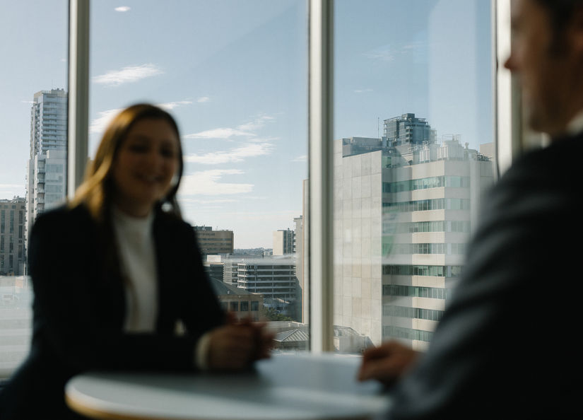 Man and woman sitting at a table with city scape in background