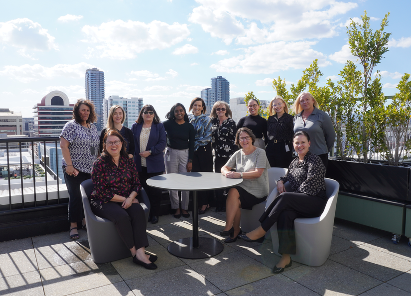 A group of administrative professionals on having a photo together on a rooftop