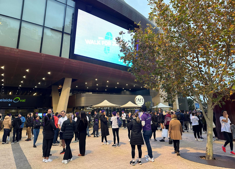 A group of people standing outside Adelaide oval about to begin the Walk for Justice
