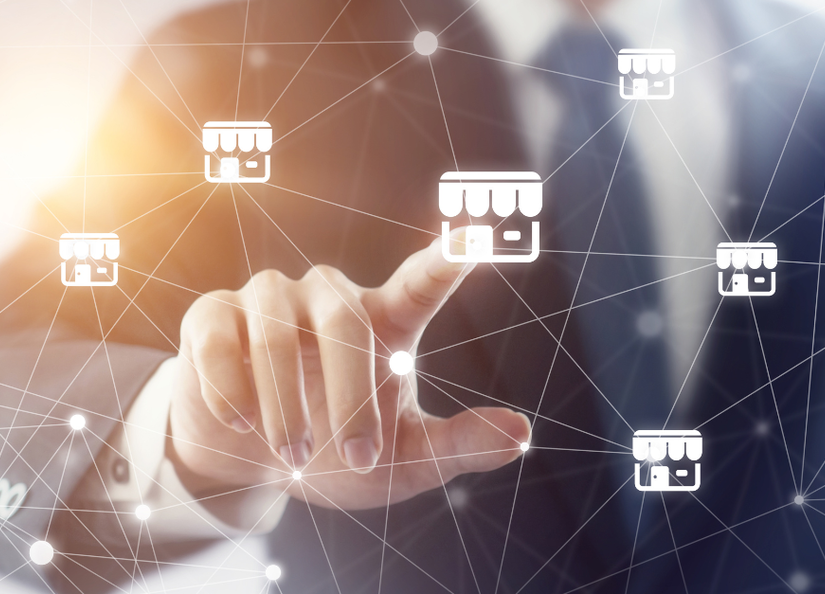 Stock image of man in suit pressing houses on a touch screen