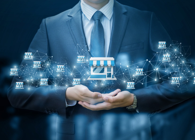 Stock image of man in a suit with arms crossed and franchise symbols super imposed over the top