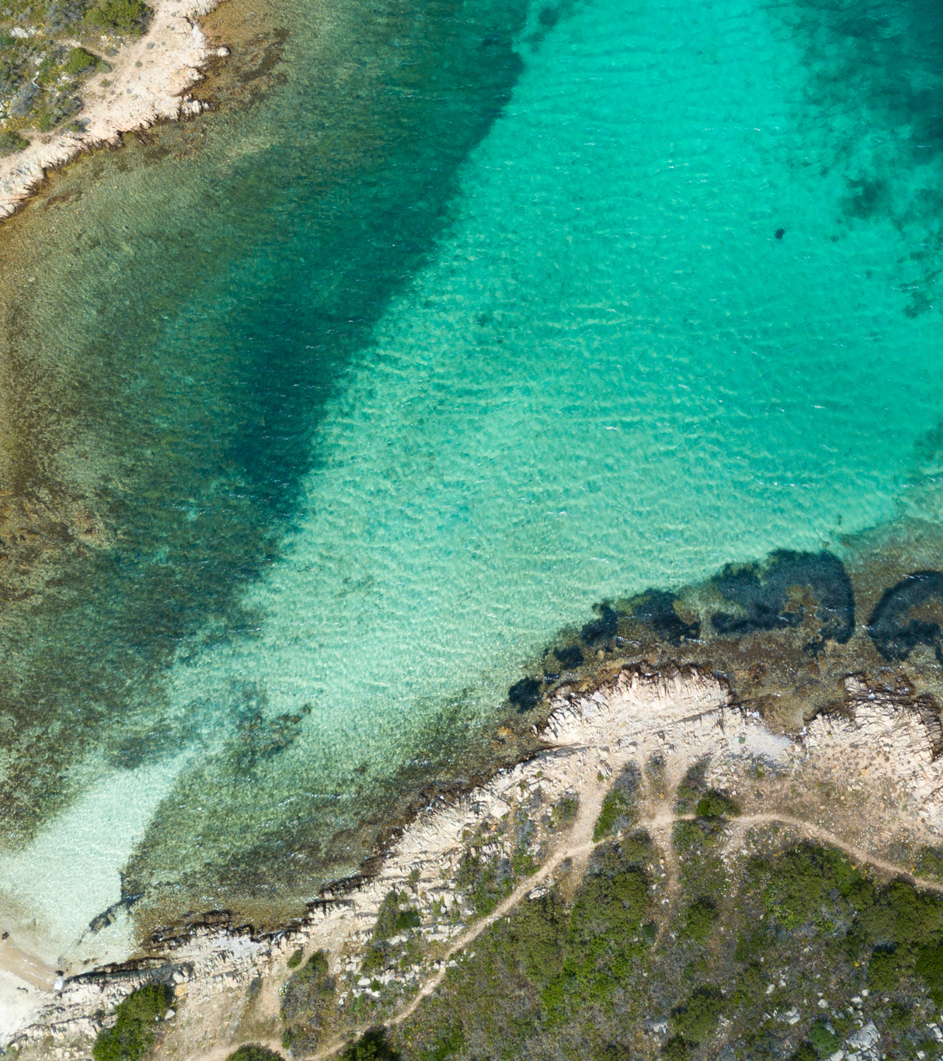 Image of coastline and clear blue/green ocean