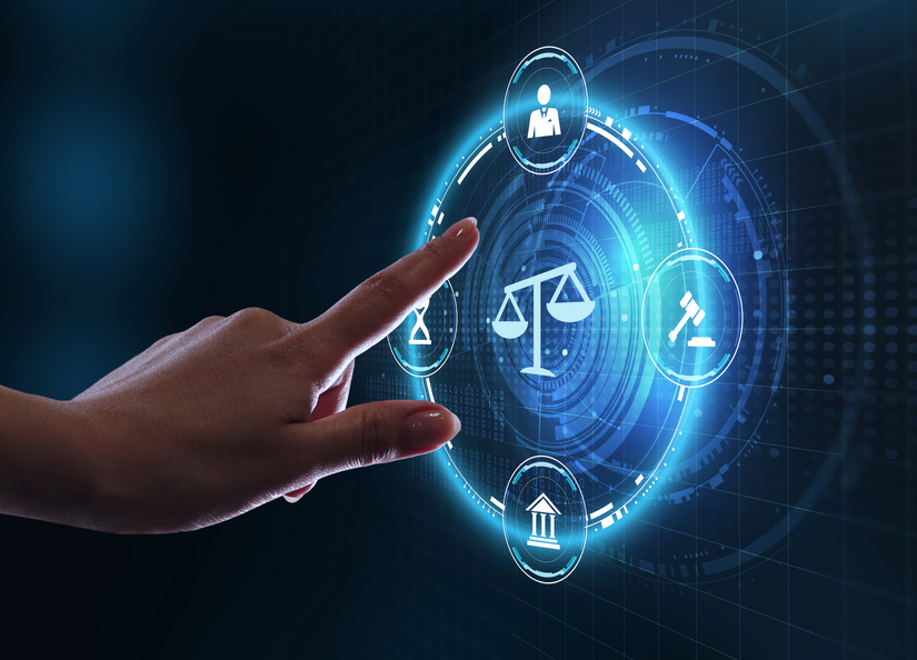 A finger about to touch a scales of justice hologram