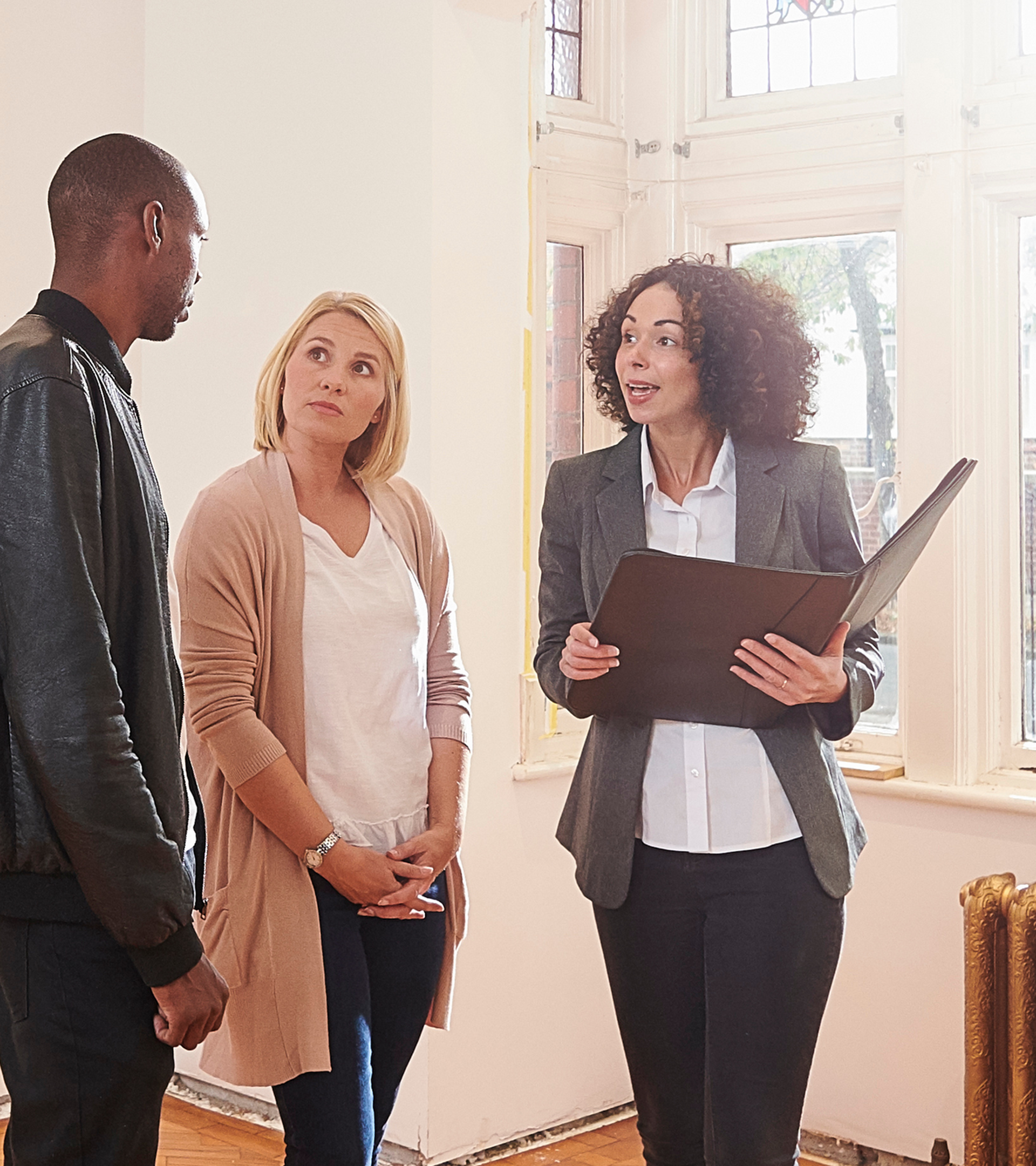 A couple talking to their conveyancer on a walk through