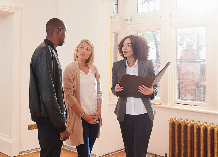A couple talking to their conveyancer on a walk through