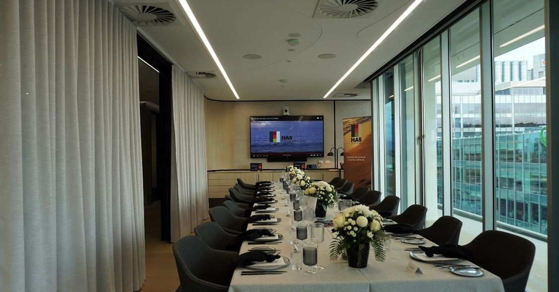 Boardroom table beautifully set and dressed up for luncheon