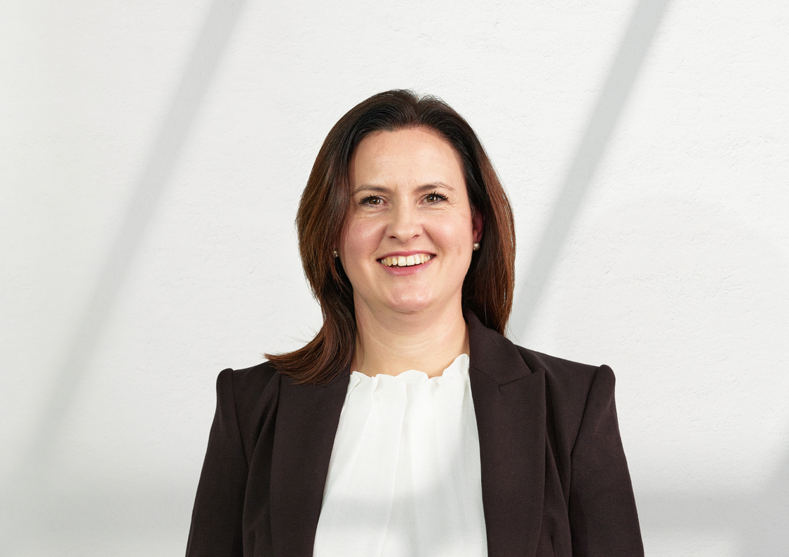 Middle aged, Caucasian senior executive woman with brown hair posing for headshot