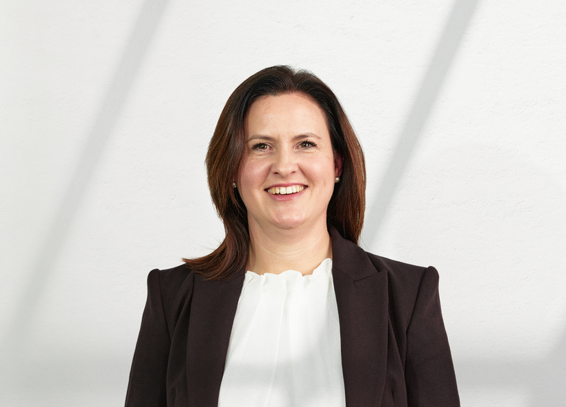 Middle aged, Caucasian senior executive woman with brown hair posing for headshot