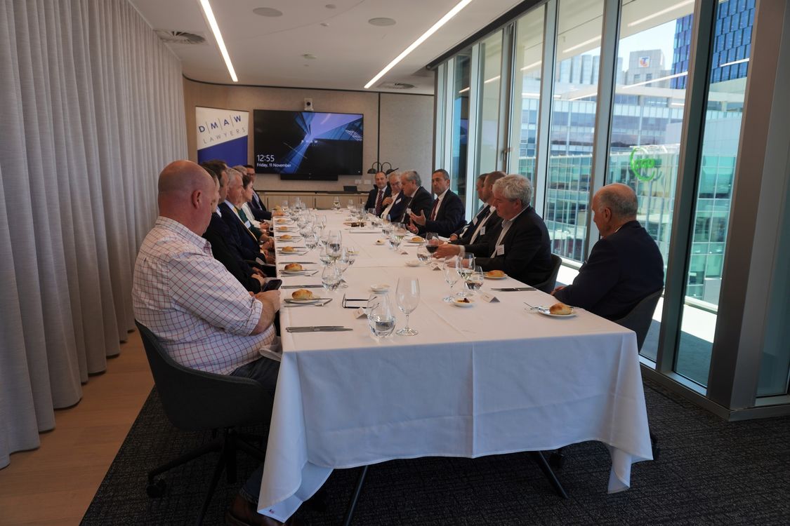 A selection of energy and resources business executives seated around a boardroom table listening to a presentation from Hon. Tom Koutsantonis MP