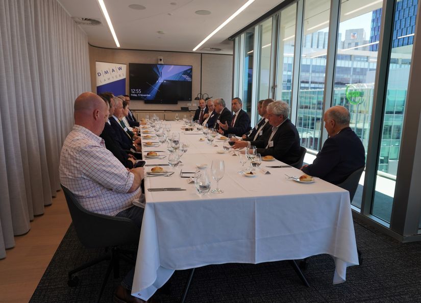 A selection of energy and resources business executives seated around a boardroom table listening to a presentation from Hon. Tom Koutsantonis MP