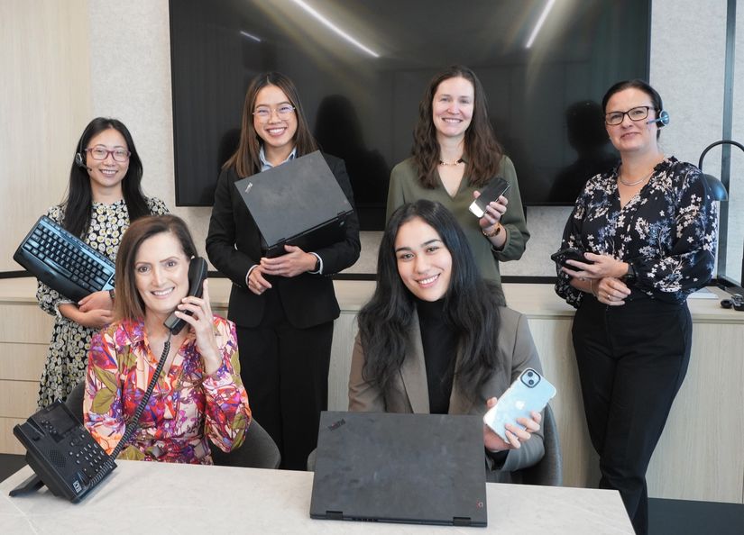 A group of diverse women using technology in an office setting
