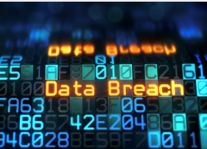The words data breach shown on a computer screen in orange among random blue numbers