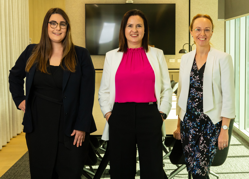 Jessica Punch, Bernice Witkowski and Kylie Dunn standing together in the centre of a boardroom