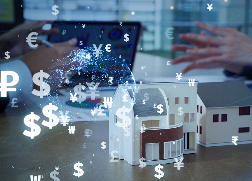 A laptop and a home model on a desk with some official looking papers and monetary symbols overlaid.